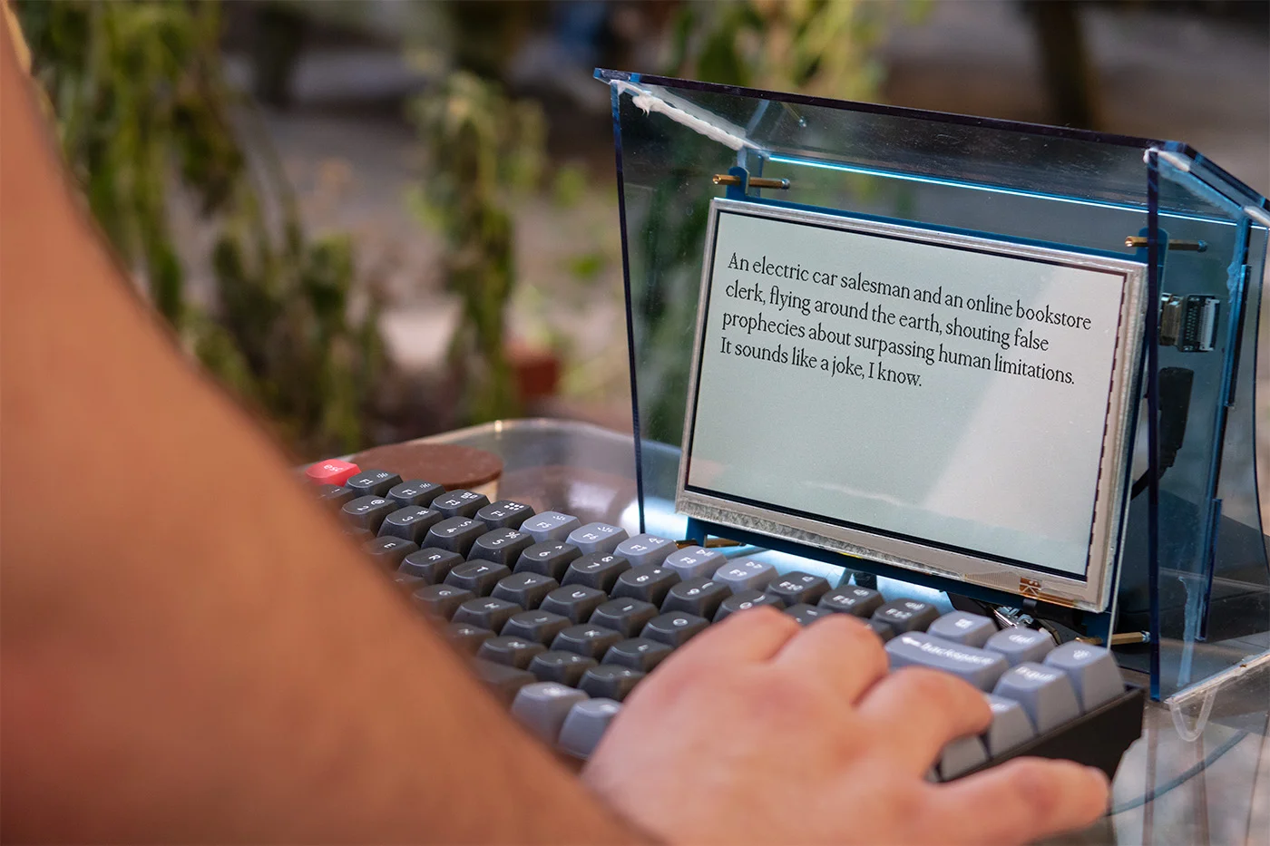 Person pressing keyboard, as small screen displays a message.